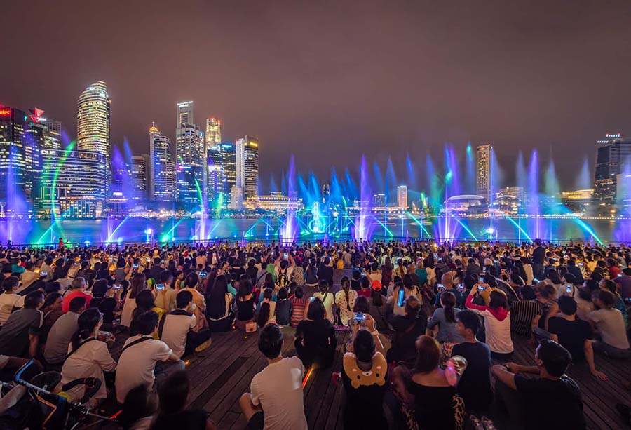 People enjoying the light show at Marina Bay Sands, Via: lonelyplanet.com
